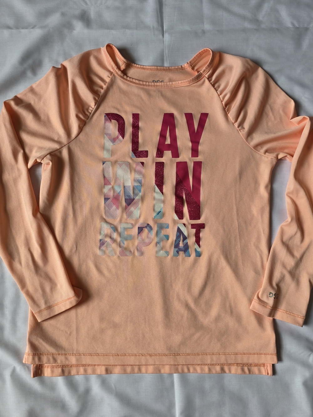 DSG Peach Long-Sleeve Girls Top with 'PLAY WIN REPEAT' Graphic